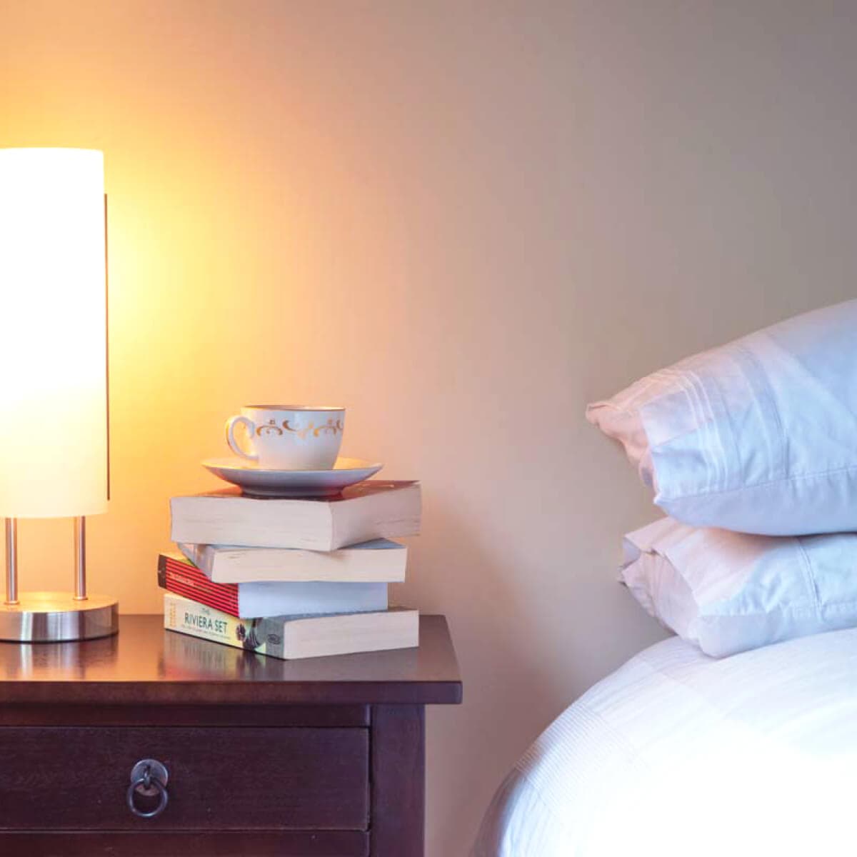 Bedside table with books on it